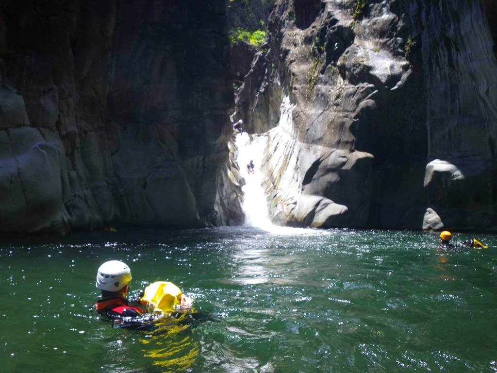 Canyoning in Trou blanc canyon, Reunion island, with a canyoning guide