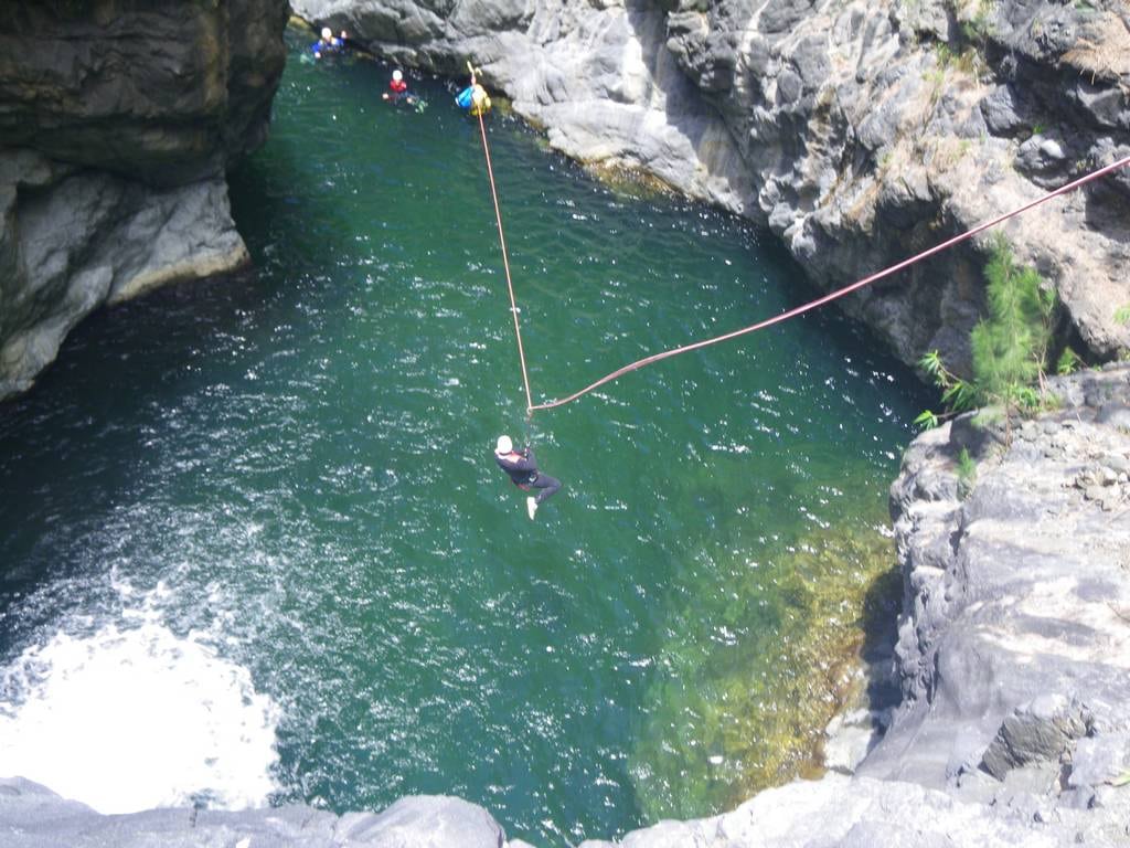 Final zip line in Trou blanc canyon, Reunion island, with an ADVENTURES REUNION canyoning guide